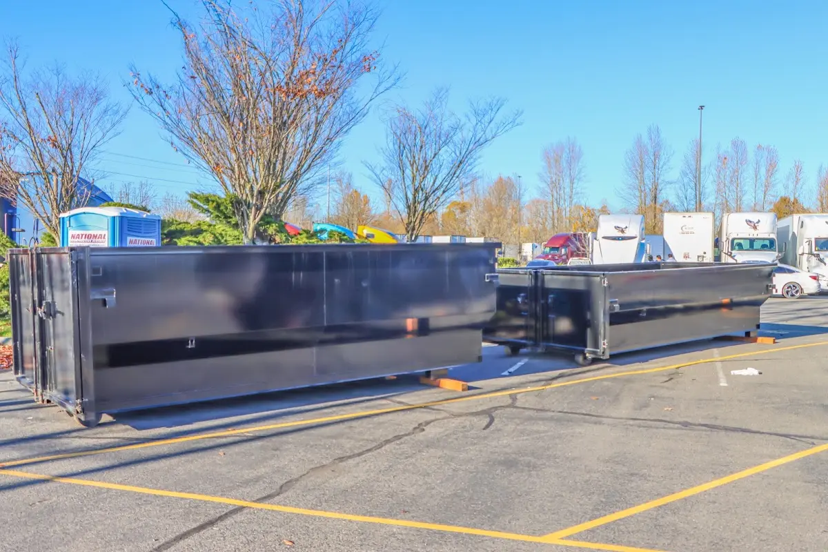 Professional dumpster rental service with roll-off container on residential driveway in Weddington